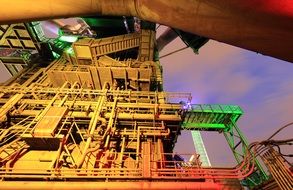 steel plant equipment in colorful lighting, germany, duisburg