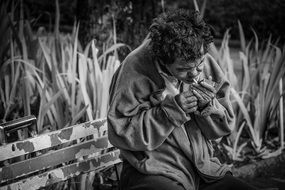 smoking old asian Man on Bench