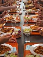 people at long table with meal in Canteen