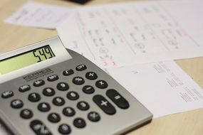 the calculator lies on white sheets