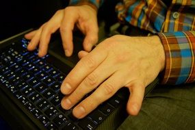 fingers on the laptop keyboard