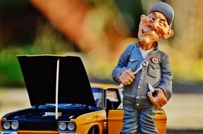 figure of the master near the model cars