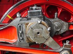 red steam locomotive wheel with mechanism