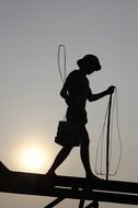 silhouette of a construction worker at dusk
