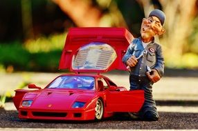 figure of the master near the red car