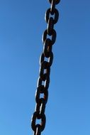 iron chain against a blue sky