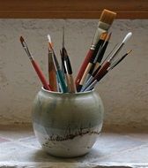 paint brushes in a vase