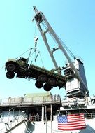 crane loading military equipment