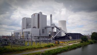 panoramic view of a power plant under a cloudy sky