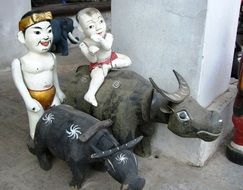 figures of people sitting on bulls