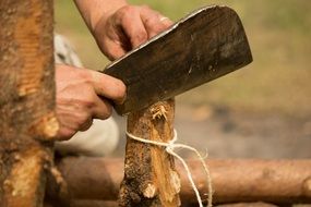 a man works with a knife on wood