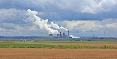 agricultural field against the background of an industrial factory in Germany