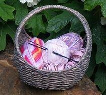 wicker basket with multi-colored threads for knitting