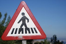 pedestrian on a road sign in the bright sun