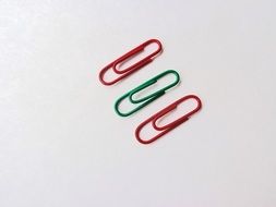 multicolored paper clips on white background