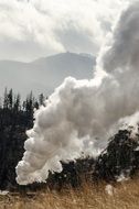 industrial smokestack in mountains