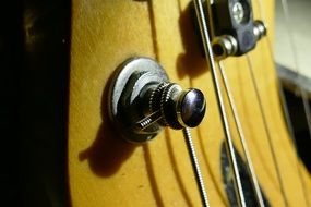 closeup picture of tuning the strings on the guitar