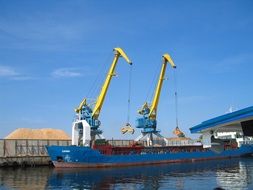 cargo ship in port beneath Cranes, Latvia, Riga