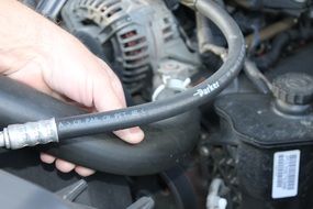 hands on a car engine close-up