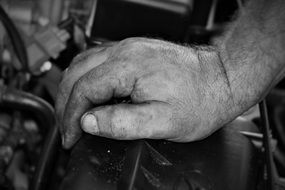 dirty male Hand on Motor of Car