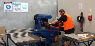 young man works at Milling Slotting in workshop