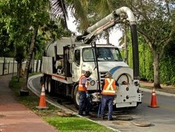 workers near the sewer hatch