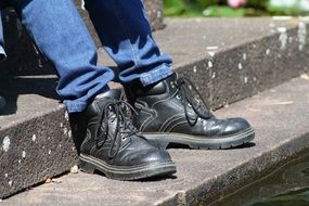 Black work shoes on the man's legs