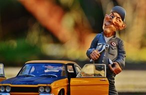 figure of a mechanic near the yellow Ford