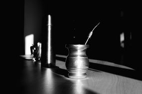 Cup of tea and a thermos of black and white photos