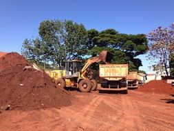trucks and excavator at a construction site