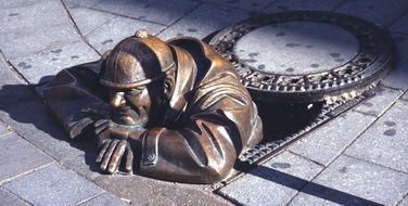 bronze statue of a fireman in a well