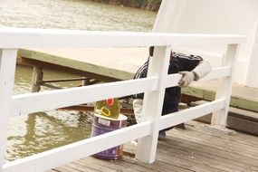 painting the fence along the pier