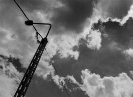 black and white photo of a pillar against the sky
