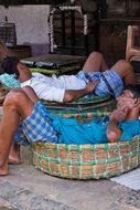 sleeping workers in baskets in india