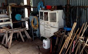 tools, carpentry table and chest of drawers in the barn