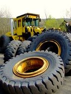 Tractor behind pile of weathered Tires