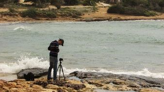 photographer with tripod on the beach