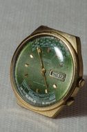 green dial mechanical watch without numbers