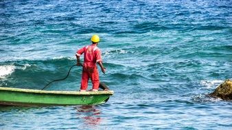 uniformed Worker in Boat on sea