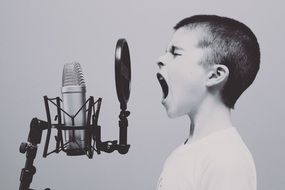 boy shouts into the microphone