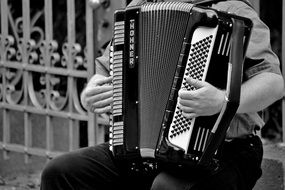 street musician with accordeon in black and white background