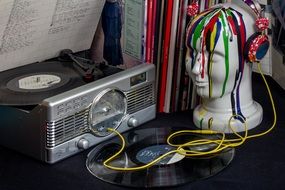 vintage vinyl record player and painted head mannequin in Headphones