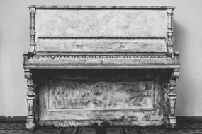 black and white image of an old piano