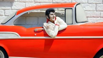 Elvis Presley mannequin in red car