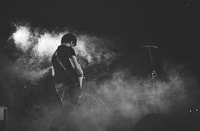 rock guitarist in smoke at a concert