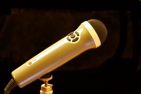 golden microphone on black