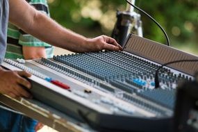DJ works at the mixing console