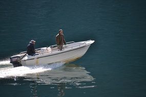 two man in motor boat on Prince Christian Sound waterway, greenland