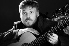 portrait of a guitarist with an acoustic guitar