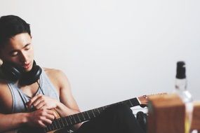 boy in headphones Playing Guitar